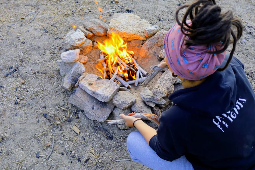 Tending to a campfire ring.