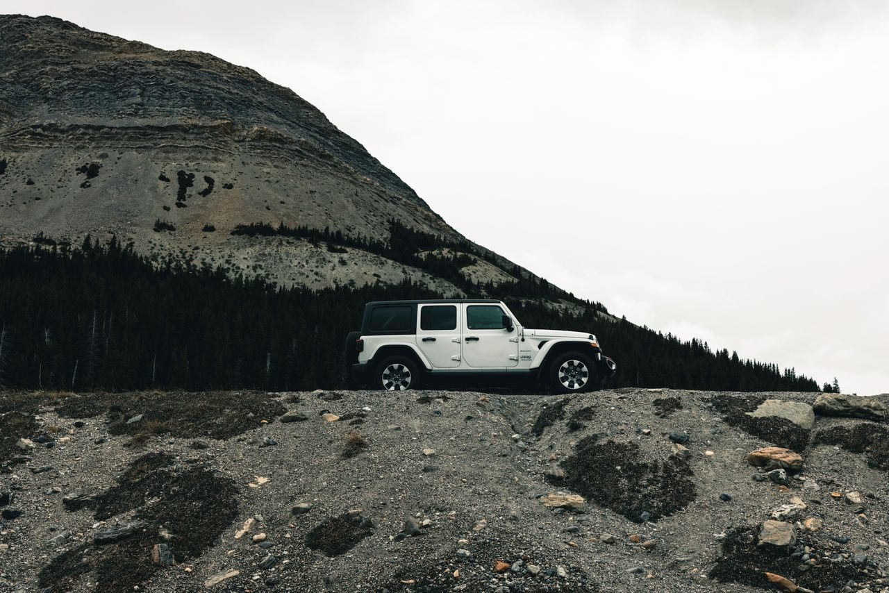 Explore scenic landscapes with a rugged vehicle in Banff's wilderness.